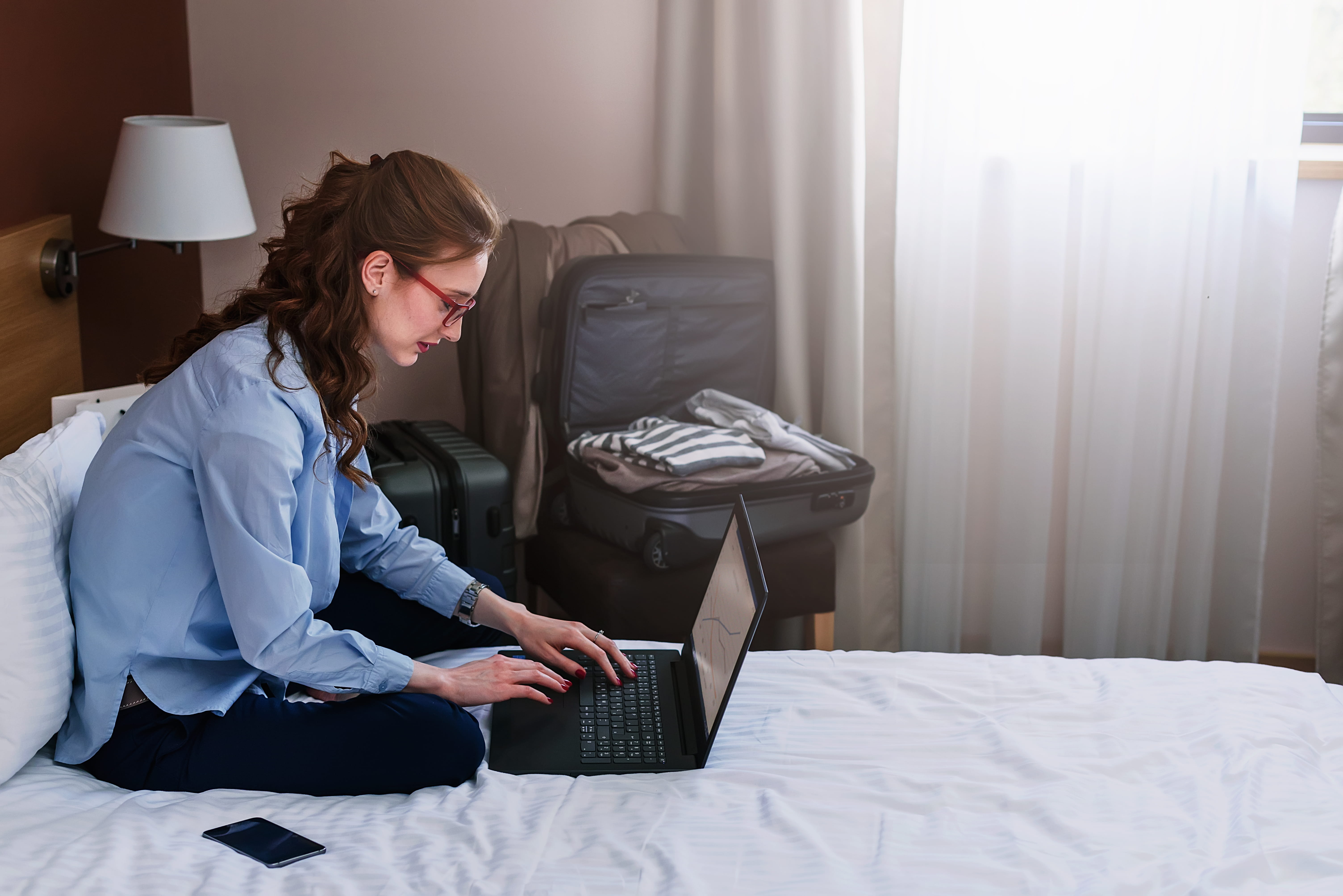 Businesswoman using a laptop while preparing for an international move